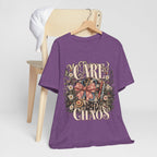 "Care With A Little Chaos" Coquette Nurse T-Shirt — Cute Nurse Graphic Tee