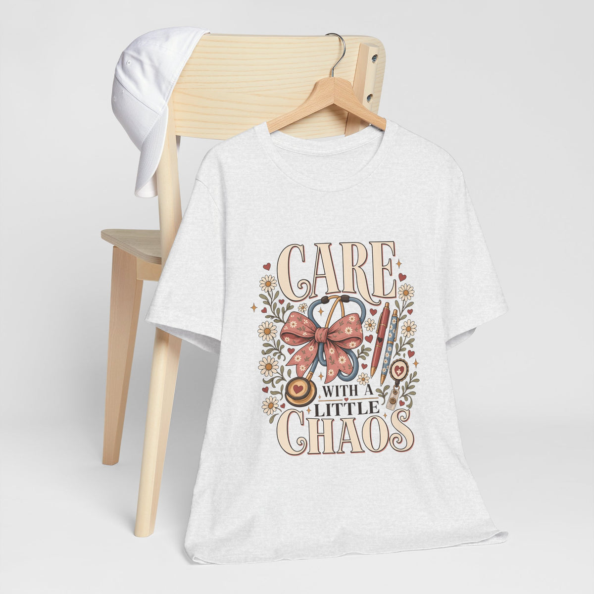 "Care With A Little Chaos" Coquette Nurse T-Shirt — Cute Nurse Graphic Tee
